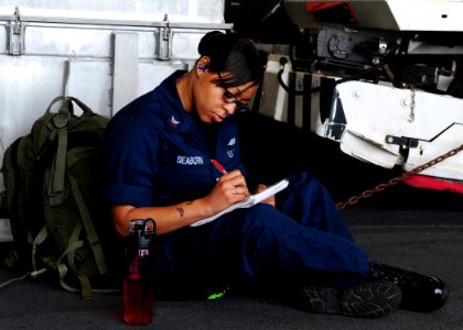 111027-N-NR955-012 - HM2 April Seaborn completes homework aboard the amphibious assault ship USS photo