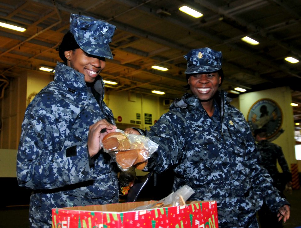 111220-N-KM939-016 - CPO Mattie Hackney gives a sailor cookies during an event sponsored by the USO