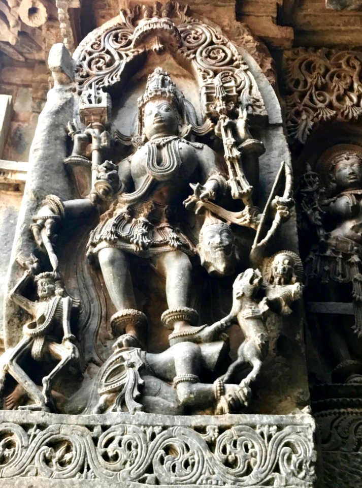12th-century angry Shakti Devi killing demons at Shaivism Hindu temple Hoysaleswara arts Halebidu Karnataka India