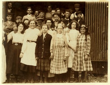A group of girl workers at Greenabaum's Cannery, Seaford, Del. The girls in the front row are 'cappers' and 'layers.' They range from 6 years of age up. Working from 10 to 12 hours per day. LOC nclc.00800