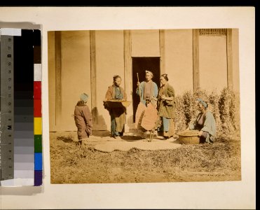A group of people, possibly street vendors or farmers, two men and two women, two are holding baskets, and one person with back to camera may be a woman LCCN2009632881