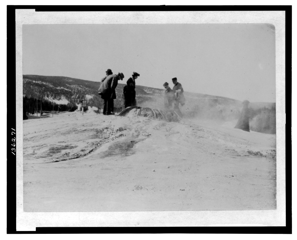A group of tourists explore a geyser in the Upper Geyser Basin in Yellowstone National Park LCCN2006676009