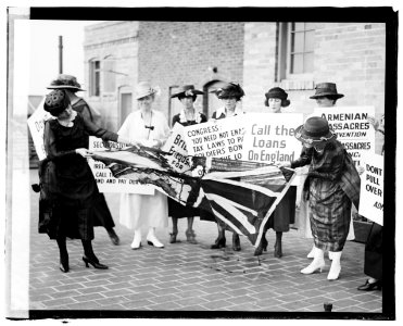 A group of women on the sidewalk, carrying signs against America's involvement on the side of the English against the Irish, and tearing up a British flag, June 3, 1920 LCCN2016828075