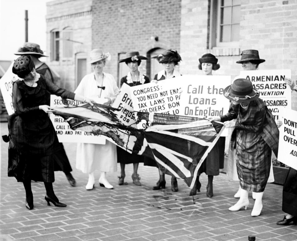 A group of women on the sidewalk, carrying signs against America's involvement on the side of the English against the Irish, and tearing up a British flag, June 3, 1920 LCCN2016828075
