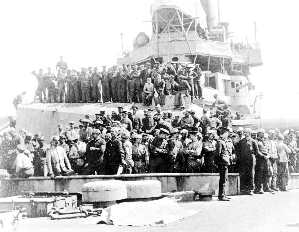 A group photograph, including German prisoners, on board HMS Inflexible (1907) RMG C6951A