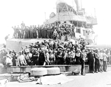 A group photograph, including German prisoners, on board HMS Inflexible (1907) RMG C6951A