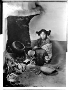 A Hopi maiden drying corn meal at a fireplace at Mishongnovi (Mashonguavi) or Oraibi, Arizona, 1898 (CHS-4587)