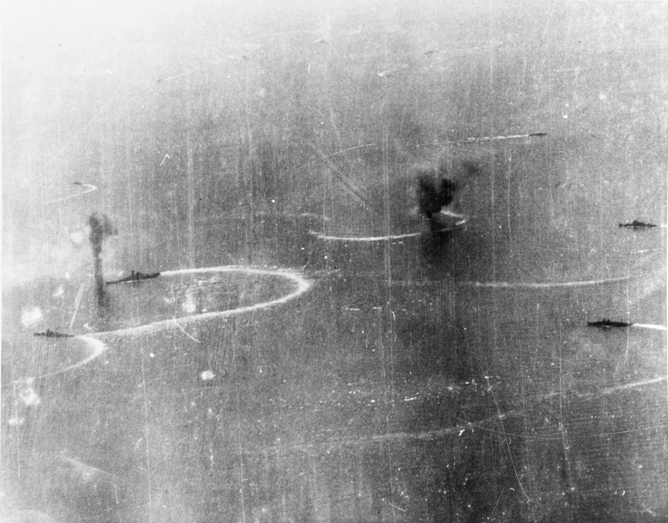 A Japanese Yamato-class battleship and other ships maneuver under attack in the Sibuyan Sea, 24 October 1944 (80-G-272550)