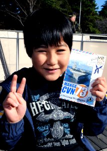 A Japanese boy poses with his copy of Manga CVN 73