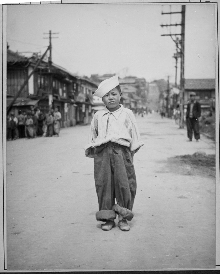 A Korean orphan boy adopted by a motor pool battalion at Inchon, Korea and nursed back to health. He is called... - NARA - 520795