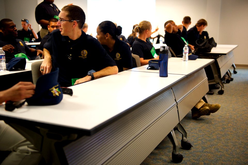 A law enforcement explorer speaks to someone behind him