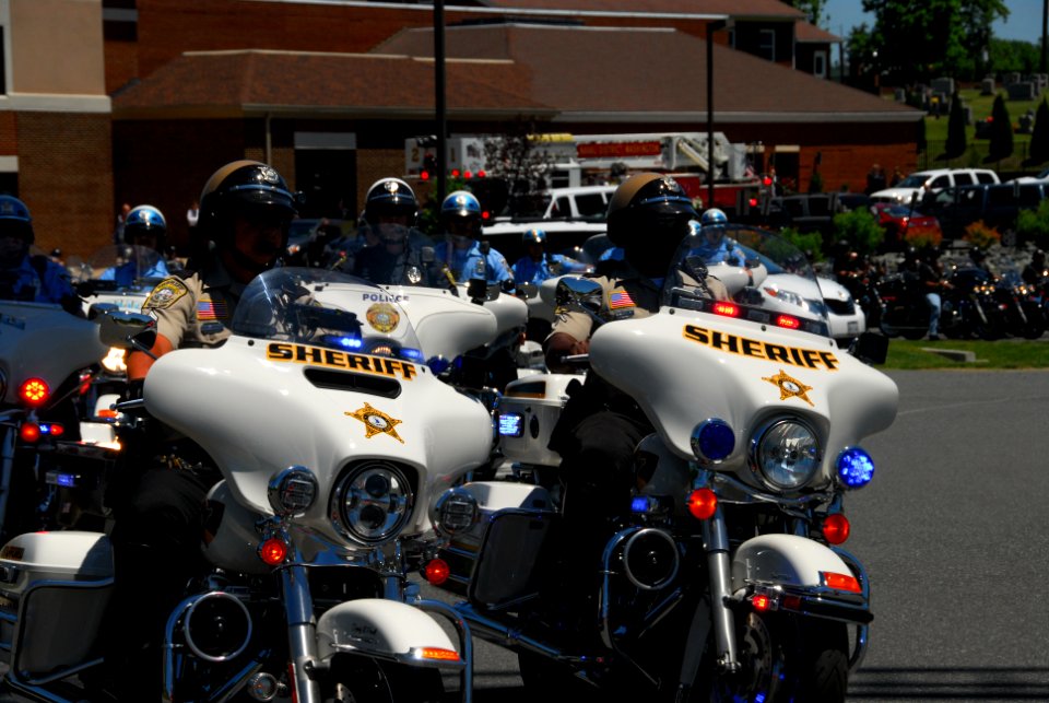 A large motorcycle escort 140606-N-CG900-061