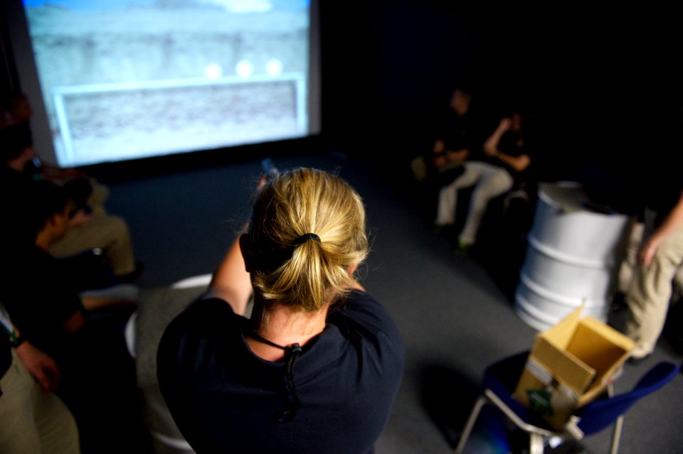 A law enforcement explorer aims at her target with a practice weapon