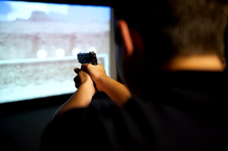 A law enforcement explorer takes aim with a practice weapon during a drill