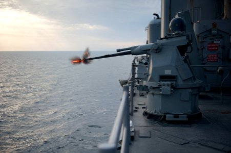 A machine gun aboard USS Pearl Harbor fires rounds during a live-fire exercise. (6807746655)