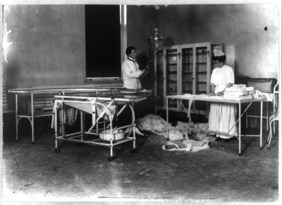 A man and a woman working in an operating room LCCN2006681348