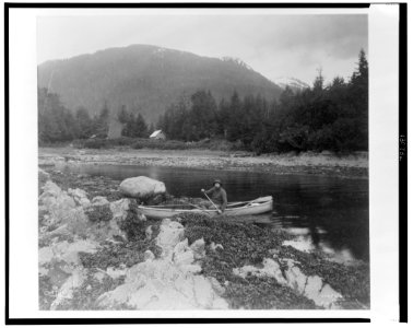 A man, possibly Lewis Rutherford Morris, seated in a canoe on a river in Alaska, 1899) - Curtis LCCN2002706859