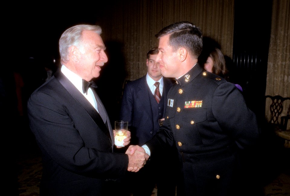 A Marine Corps major shakes hands with Walter Cronkite