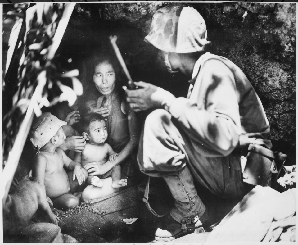 A member of a Marine patrol on Saipan found this family of Japs hiding in a hillside cave. The mother, four children an - NARA - 532380