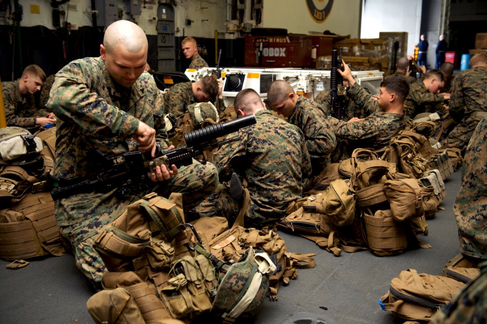 A Marine cleans his weapon at sea. (8435773272)