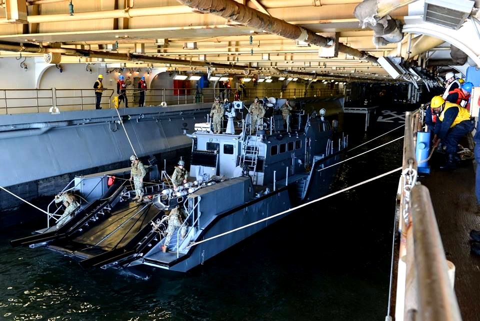 A mark VI patrol boat docks with the USS bataan