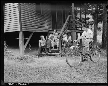 A miner and children on steps of a typical house. Kingston Pocahontas Coal Company, Exeter Mine, Big Sandy Housing... - NARA - 540760
