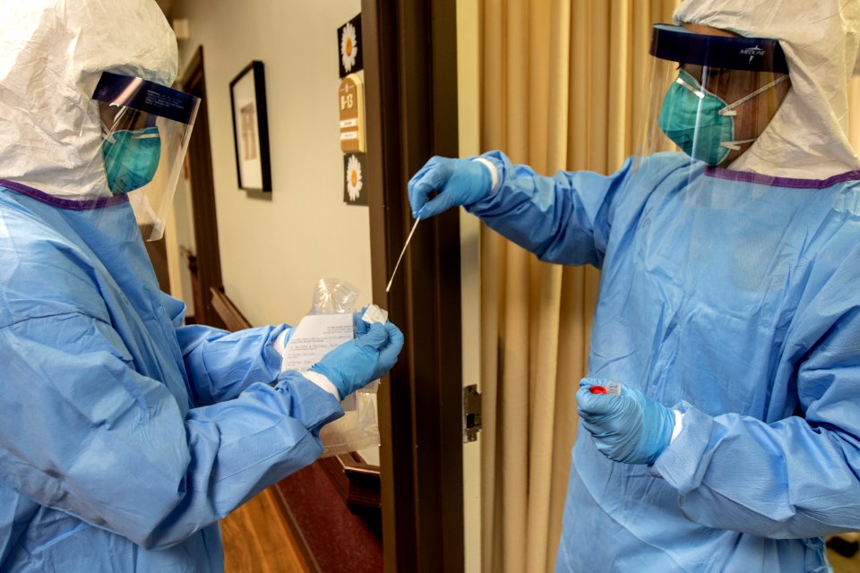 A medic with the Massachusetts National Guard takes a nasal swab that will be used to test for COVID-19 with a resident of the Life Care Center of Nashoba Valley Littleton Mass. April 3 2020