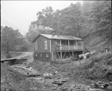 A miner's house by the dirty stream which is used for garbage and trash disposal. Raven Red Ash Coal Company, No. 2... - NARA - 541068