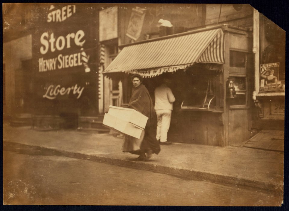 A mother carrying flowers home to be made. 210 Sullivan St., N.Y. (see 2851). LOC nclc.04172
