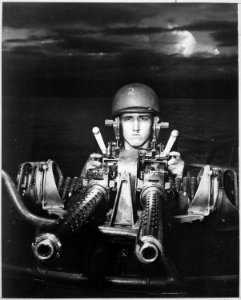 A motor torpedo boat marksman provides a striking camera study as he draws a bead with his 50 calibur machine gun on... - NARA - 520621