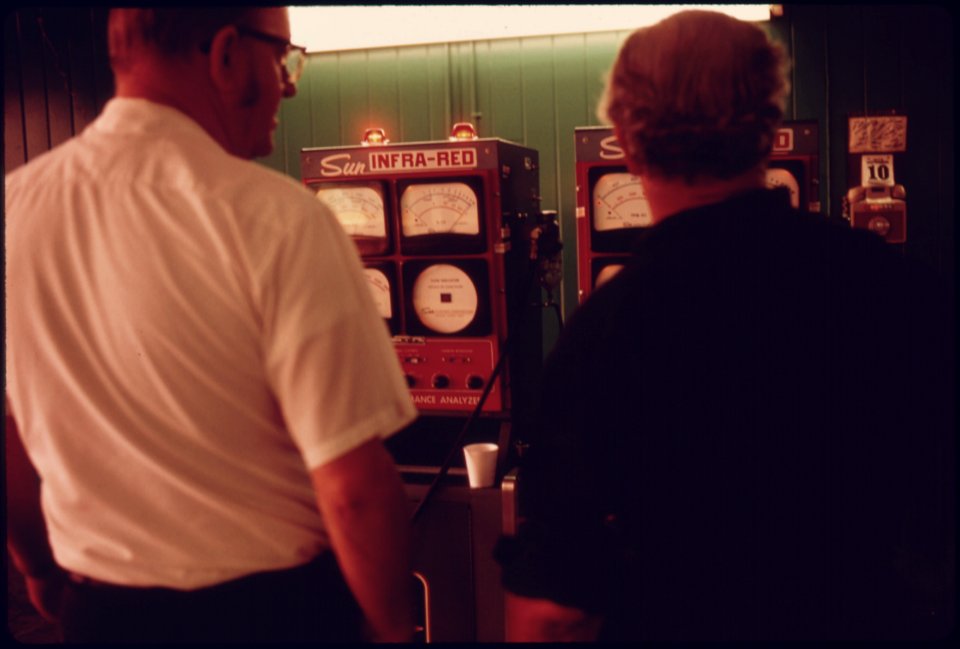 A Motorist, Right, Watches as Both Bulbs Glow on the Exhaust Analyzer...09-1975 (4266527680)