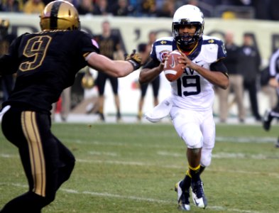 A Navy quarterback scrambles.