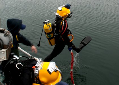 A Navy diver steps into the water. (8414176426)