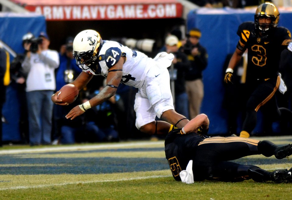 A Navy fullback dives into the end zone.
