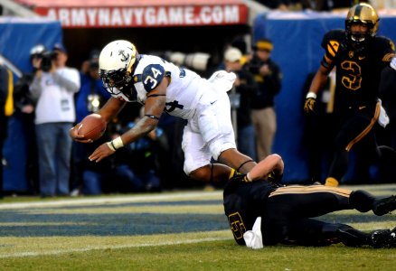 A Navy fullback dives into the end zone.