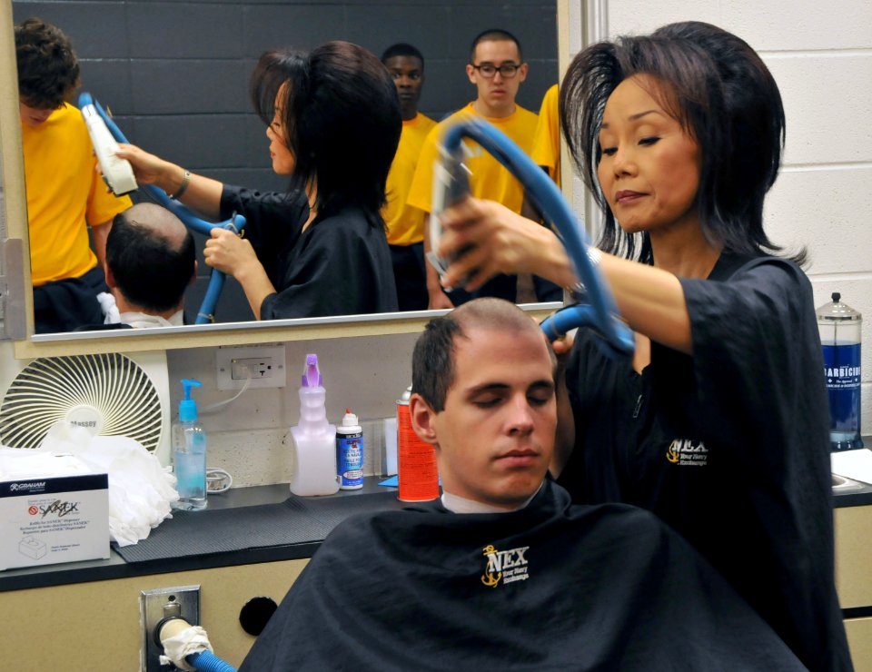 A new recruit gets his first Navy haircut
