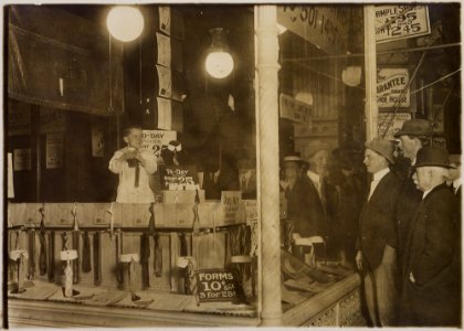 A photograph of 7-year-old Tommie Noonan demonstrating the advantages of the Ideal Necktie Form in a store window on... - NARA - 306614