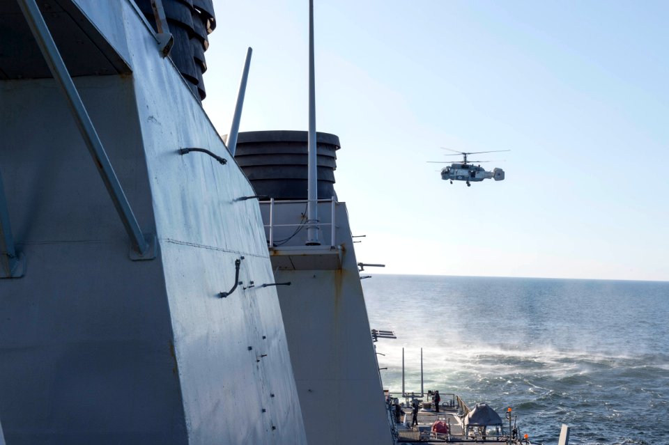 A Russian Kamov KA-27 flies near the USS Donald Cook (DDG 75)