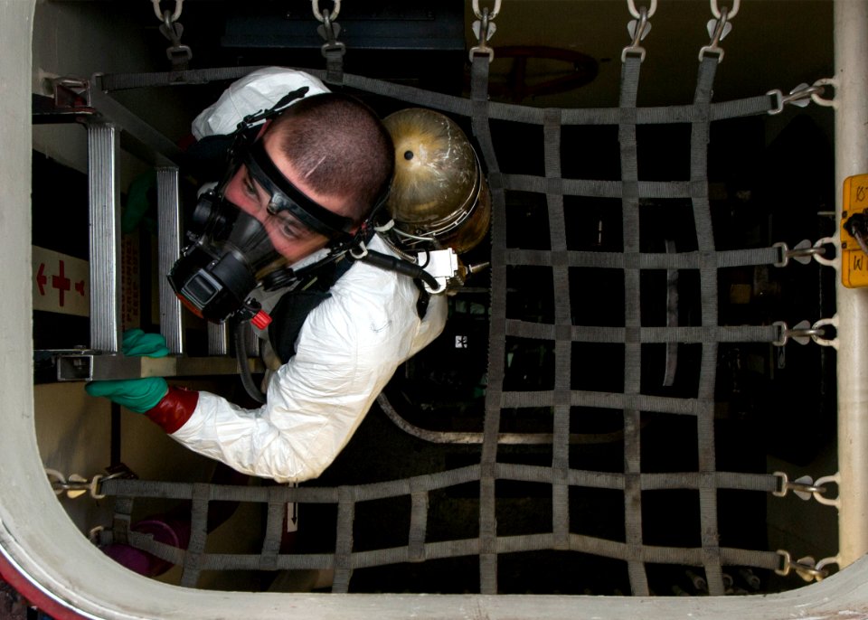 A Sailor accends a ladder during a fuel spill drill. (8426061159)