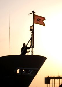 A sailor aboard the Royal Moroccan Navy frigate Mohammed V (F 611) conducts morning colors March 9, 2014, in Dakar, Senegal 140309-N-QY759-036