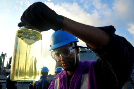 A Sailor checks a fuel sample at sea. (8185235616)
