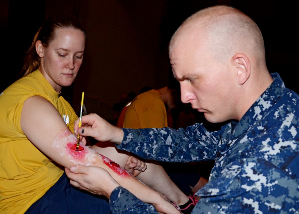 A Sailor applies fake scars for an exercise. (8190912440)