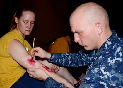 A Sailor applies fake scars for an exercise. (8190912440)