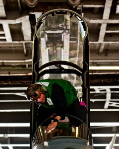 A Sailor cleans the canopy of an F A-18F. (8185238482)