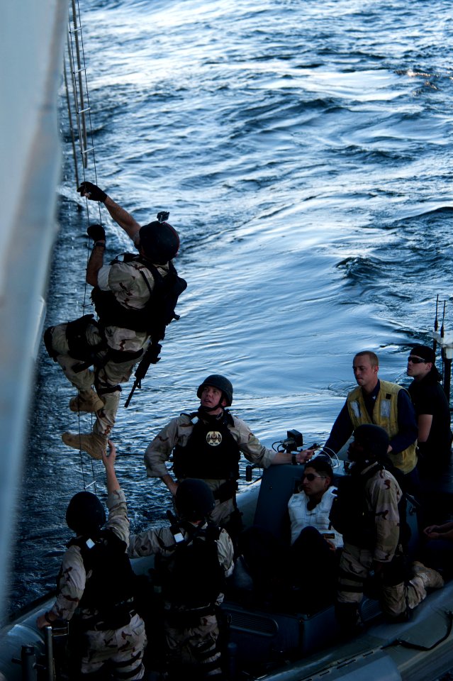A Sailor climbs aboard USS Mobile Bay during a VBSS exercise. (8468331490)