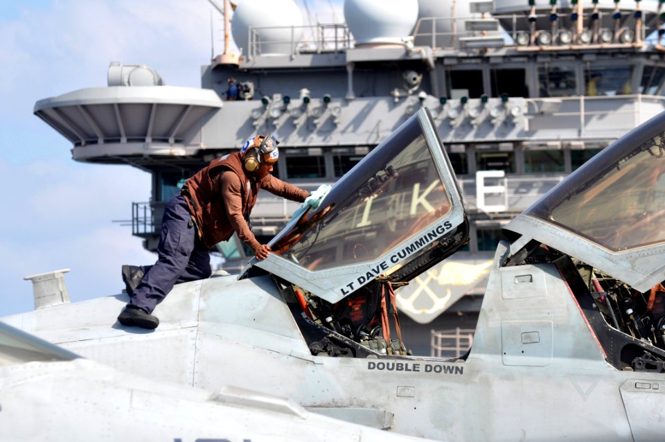 A Sailor cleans the canopy of an EA-6B. (8224207586)