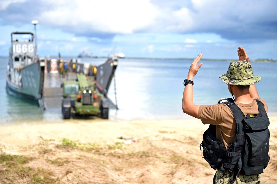 A Sailor directs a tractor onto the beach. (20353868258)