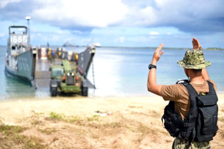 A Sailor directs a tractor onto the beach. (20353868258)