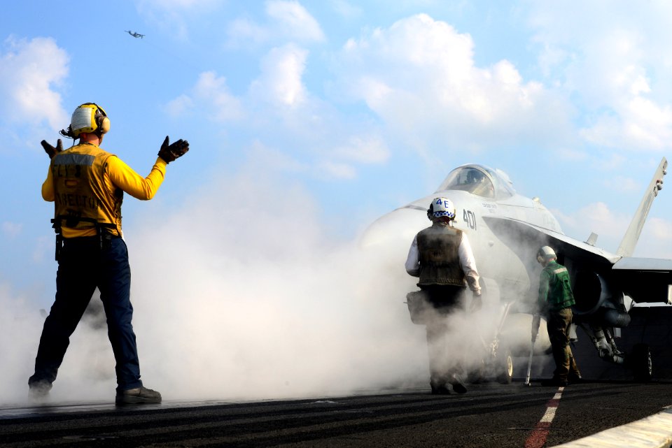 A Sailor directes an F-A-18C at sea. (8389218605)