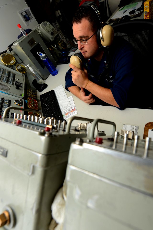 A Sailor conducts communication checks. (8284405878)